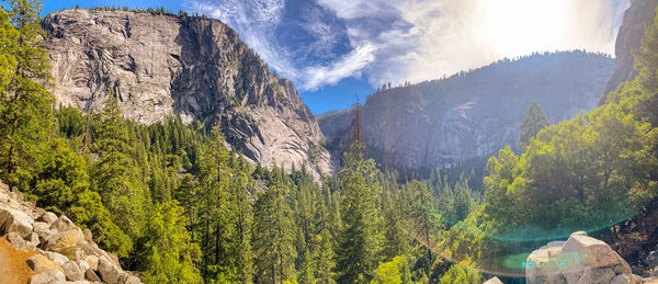 Panoramic view of rocks and trees against sky