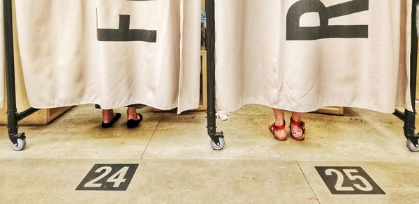 Low section of people standing on tiled floor