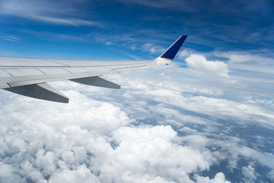 Cropped image of airplane flying over mountain