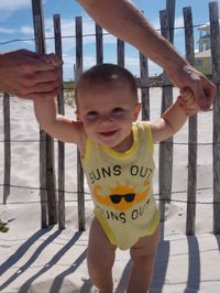 Portrait of happy boy with arms raised