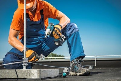 Low section of worker working at construction site