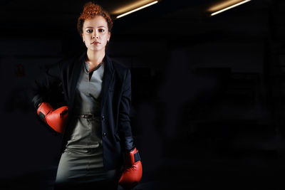 Portrait of woman wearing boxing gloves