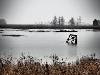 Scenic view of lake against sky during winter