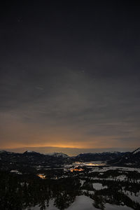 Scenic view of snowcapped mountains against sky at night