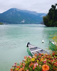 Scenic view of lake by mountain against sky