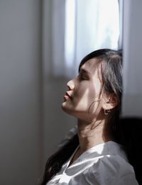 Portrait of young woman with eyes closed