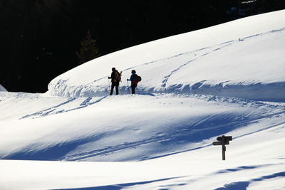 People walking on snow covered mountain
