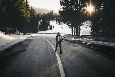 Rear view of woman on road