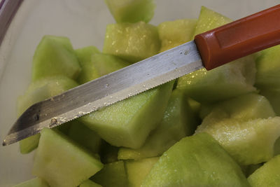 Close-up of chopped fruits in bowl on table