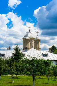 View of trees and building against sky