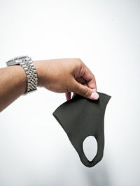 Close-up of person hand against white background