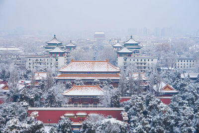 High angle view of illuminated buildings in city during winter