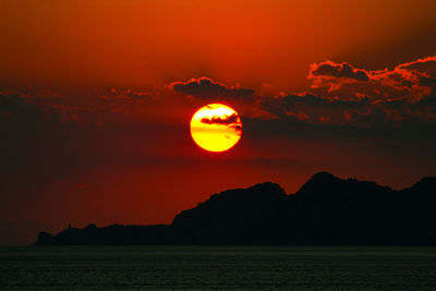 Scenic view of sea against romantic sky at sunset