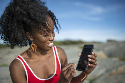 Smiling woman holding cell phone