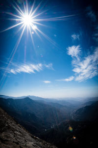 Scenic view of mountains against blue sky