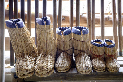 Close-up of wicker shoes on window sill