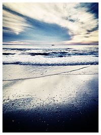 Scenic view of sea against cloudy sky