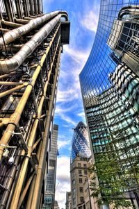 Low angle view of modern building against cloudy sky