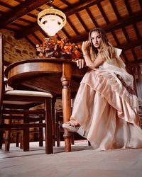 Portrait of woman sitting on table