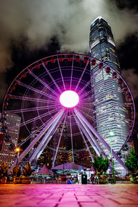 Illuminated ferris wheel at night