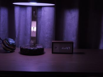 Close-up of illuminated electric lamp on table
