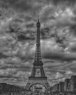 Low angle view of eiffel tower against cloudy sky