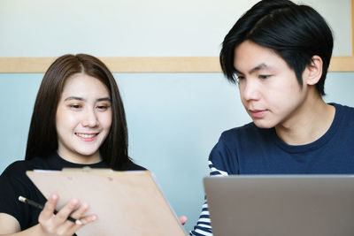 Portrait of a young woman using phone