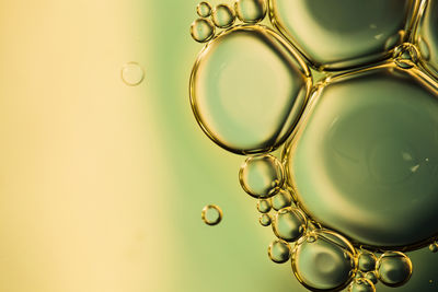 Close-up of bubbles on yellow background