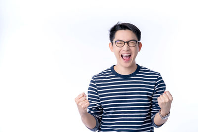 Portrait of smiling man standing against white background