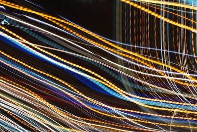 Full frame shot of light trails on black background