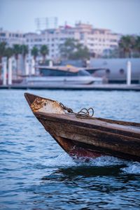 Boat moored on river in city