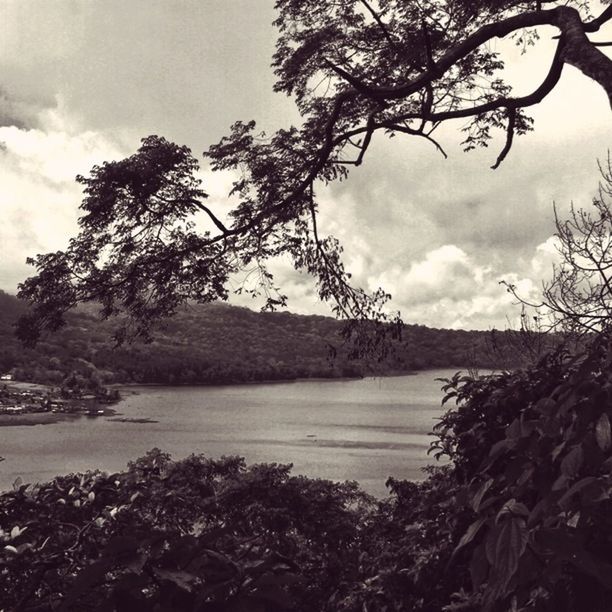 water, sky, tree, tranquil scene, tranquility, cloud - sky, scenics, nature, beauty in nature, river, lake, cloud, cloudy, branch, transportation, rock - object, lakeshore, outdoors, mountain, sea