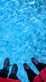 Low section of people standing by swimming pool