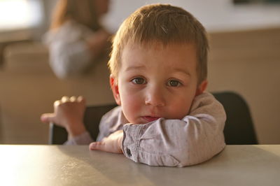 Close-up of cute baby boy lying on bed at home