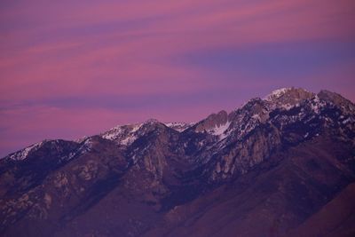 Scenic view of snowcapped mountains against sky during sunset