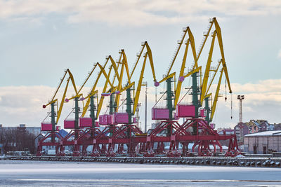 Massive harbor cranes in seaport. heavy load dockside cranes in port, cargo container yard, terminal