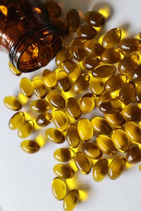 High angle view of yellow bottles on table