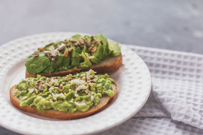 Vegan avocado sandwich on a white plate 