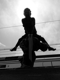 Low angle view of statue against sky