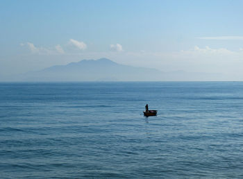 Boat sailing on sea against sky