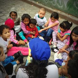 High angle view of children and multi colored umbrellas