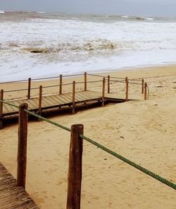 Wooden posts on beach