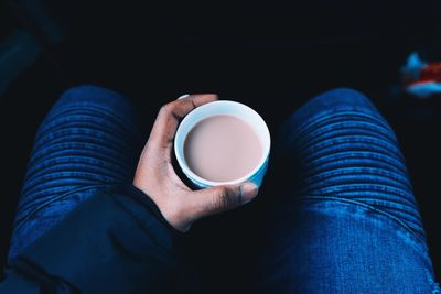 Midsection of person holding coffee cup