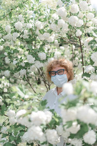 Portrait of young woman with cherry blossoms in spring