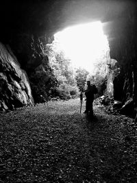 Rear view of silhouette man standing on rock