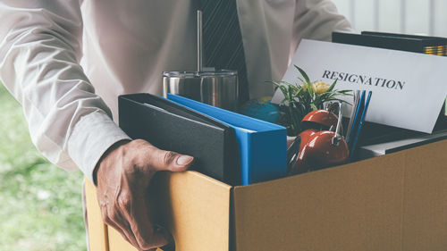 Midsection of businessman holding gift box