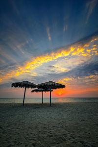 Scenic view of beach against sky during sunset