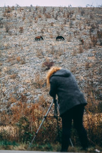 Rear view of man standing on rock