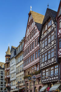 Low angle view of buildings against blue sky