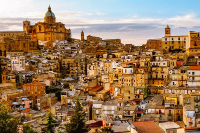 View of cityscape against cloudy sky